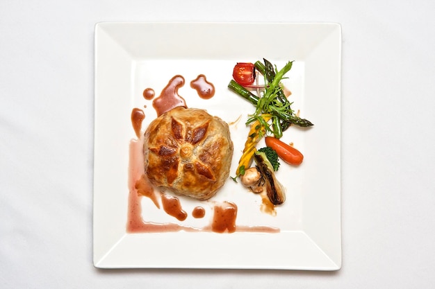 Wellington steak in puff pastry with roasted vegetables beef Wellington food gastronomy