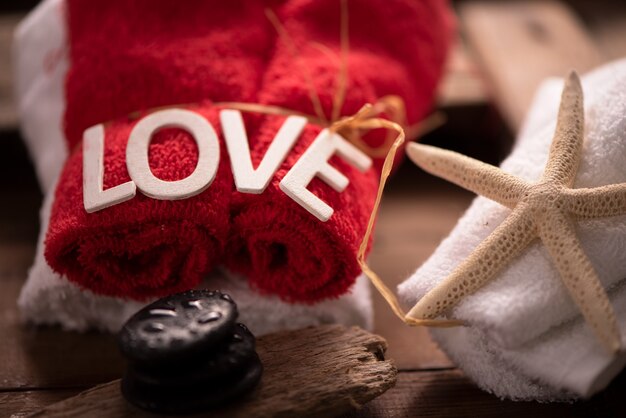 Wellness docoration on valentine`s day with towels and stones close up