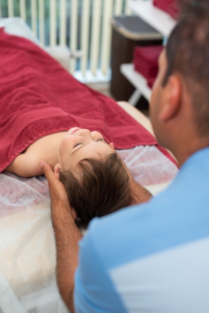 Wellness massage for children Hands of the masseur closeup Physiotherapist working with patient