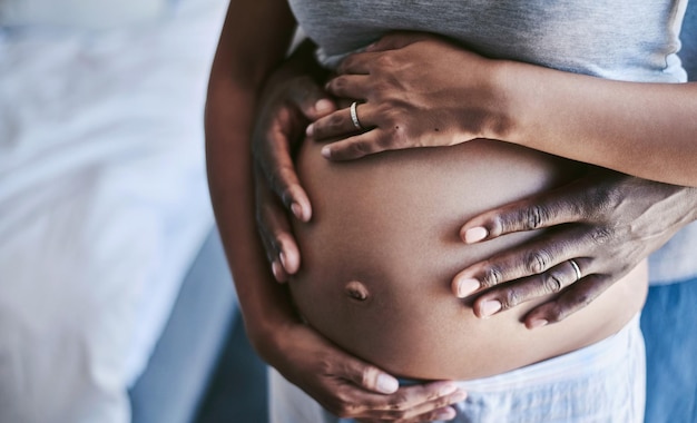 Were going through this pregnancy together Cropped shot of an unrecognizable man and his wife touching her pregnant belly