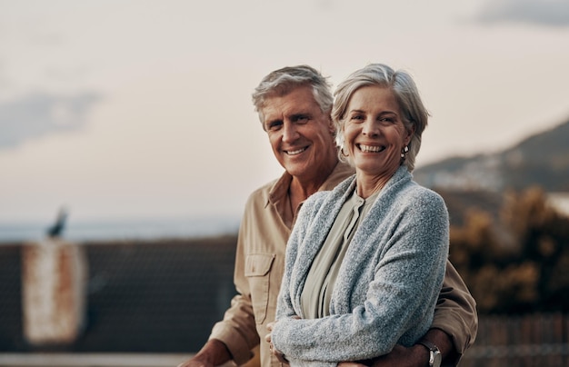 Were happy to be celebrating yet another new year together Cropped portrait of an affectionate mature couple smiling while standing on a balcony outdoors