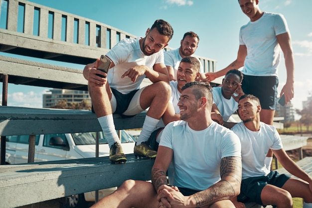 Were trending online guys Shot of a rugby player showing his teammates something on his cellphone