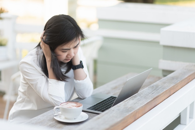 Werkende vrouwen hard denkend en werkend met laptop in het café