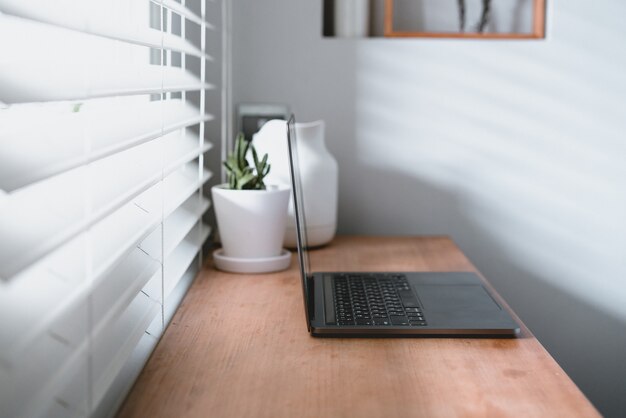 Werkplek in de buurt van het raam met laptop en computer. Ruimte kopiëren. gebruik in het traditionele Chinese alfabet-besturingssysteem.