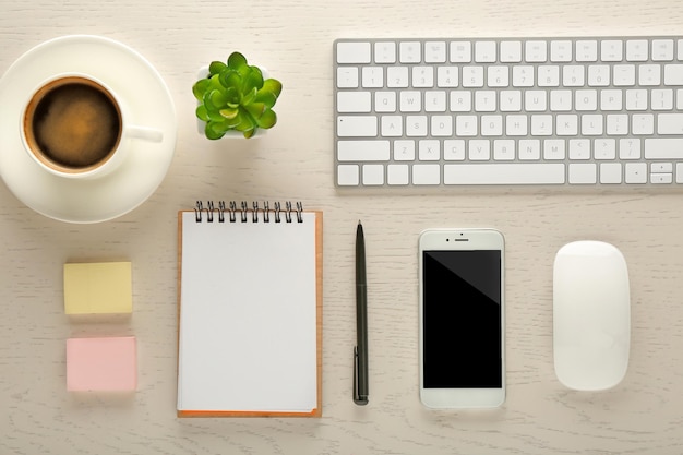 Werkplek met randapparatuur van mobiele telefoons en briefpapier op lichttafel