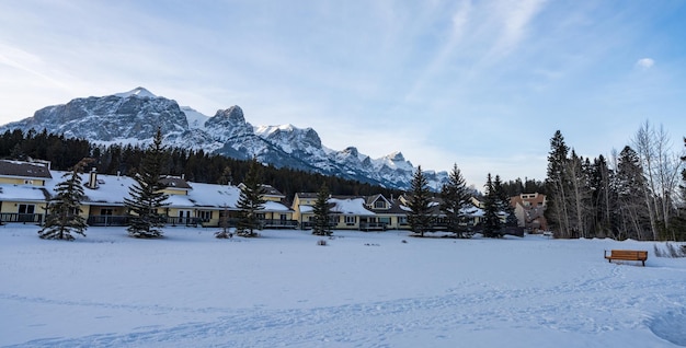 West canmore park in winter row of lodge and snowcapped\
canadian rockies mountain range