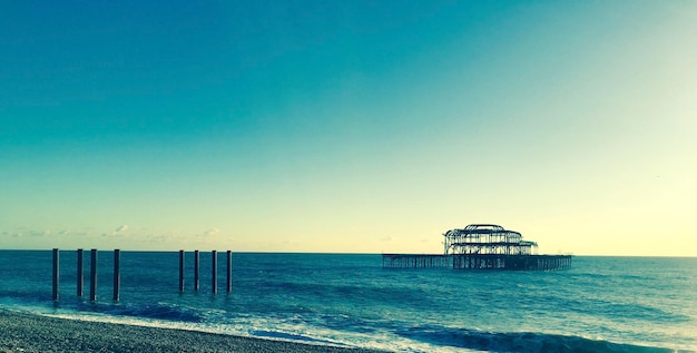 West pier in sea against clear sky