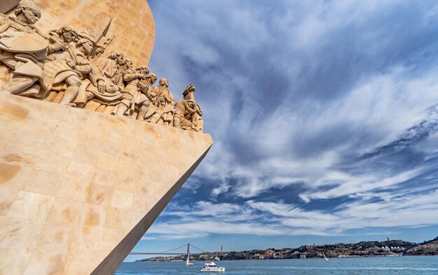 Western profile of the Monument of Discoveries in Lisbon Portugal Europe with sailboats and boats