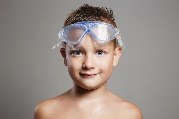 Wet child in swimming goggles