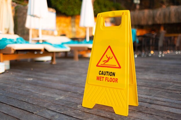 Photo wet floor caution sign on hotel terrace