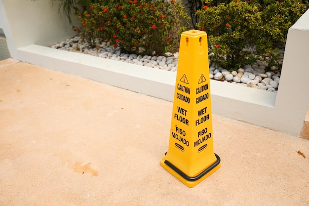 A wet floor warning sign on a wet floor