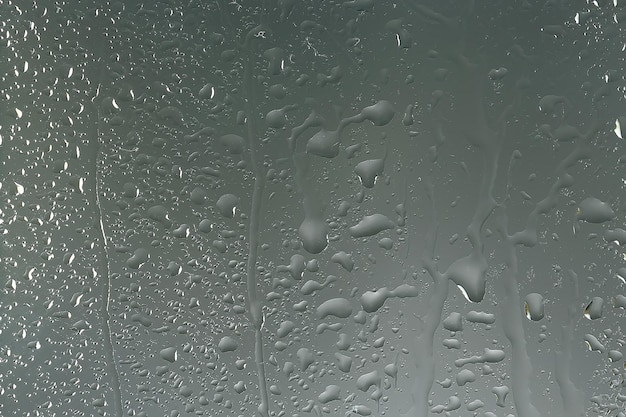 Photo wet glass background condensate / abstract rain, drops texture on transparent glass