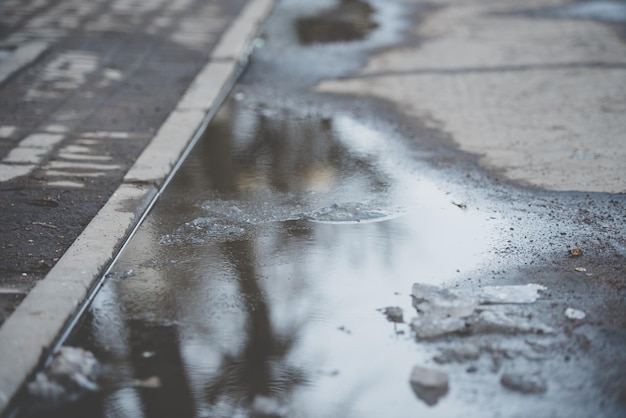 Wet spring sidewalk in town