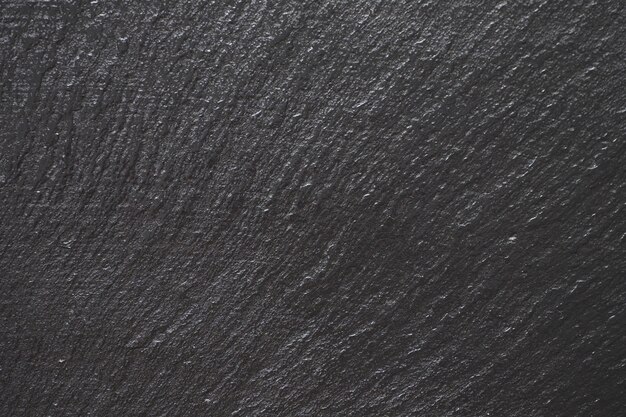 Photo wet textured stone black surface. abstract dark stone surface texture background.