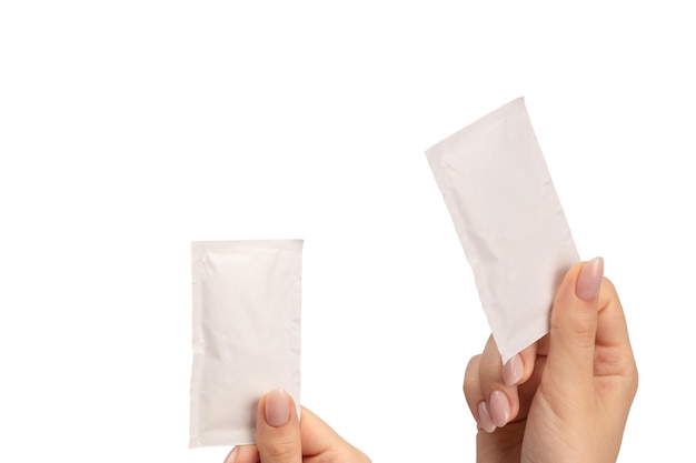 Wet wipe in a woman hand isolated on a white background