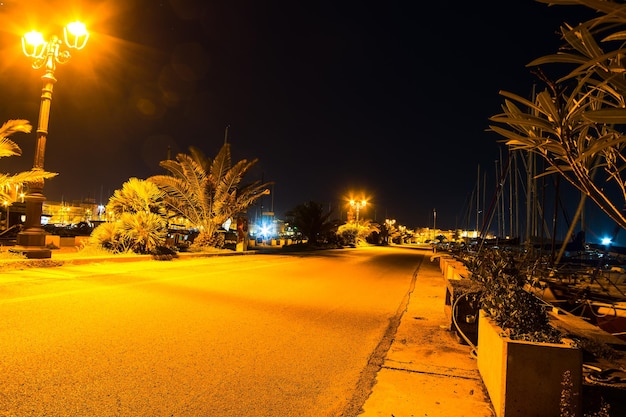 Wharf in Alghero harbor by night Italy