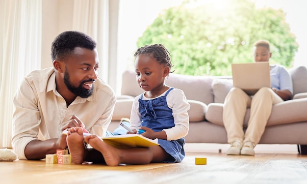 What colour should that be. Shot of a father and daughter drawing together at home.