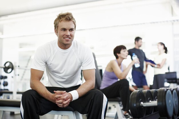 What next cropped shot of a handsome young man sitting in the gym