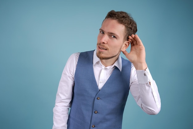 What does not hear you Handsome business guy in white shirt and blue vest