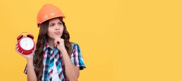 What to do early morning workers day future career thoughtful teen girl hold alarm clock Child builder in helmet horizontal poster design Banner header copy space