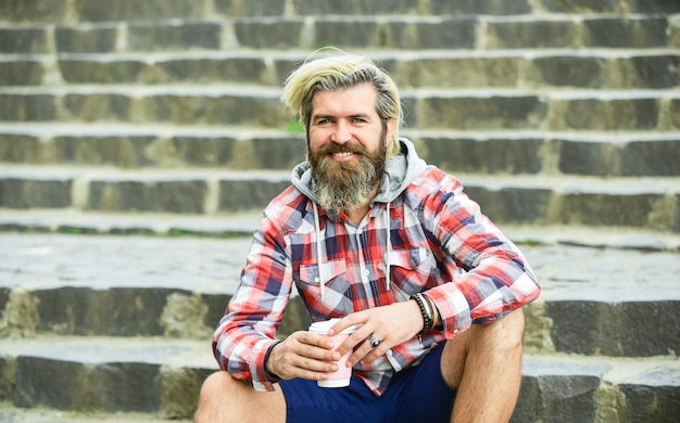 What a great morning. hipster relax on stairs. mature traveler
having rest. take away coffee. good morning inspiration. brutal man
with beard drinking tea from cup. bearded man drink coffee
outdoor.