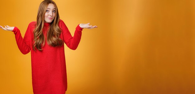 What do i know portrait of confused clueless tender and gentle redhead woman in red sweater person