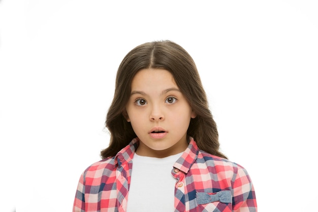 What is going on. Kid stunned bewildered emotion can not believe her eyes. Girl curly hairstyle wondering. Child bewildered confused face isolated white background. Kid girl long curly hair stunned.