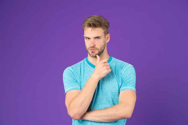 What is on his mind Man with strong muscular arms Does having muscular body make you more confident Man muscular handsome unshaven thoughtful guy on violet background Masculinity concept