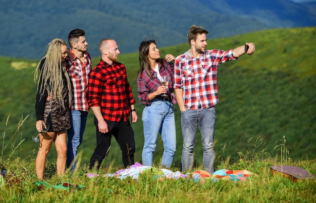 What is our next travel destination happy men and girls friends make selfie friendship romantic picnic in tourism camp summer vacation group of people spend free time together hiking adventure