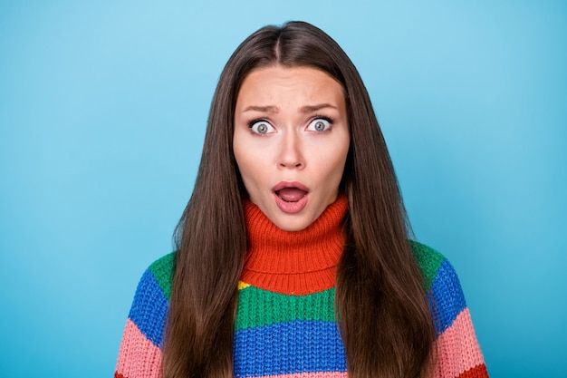 What its unbelievable. Astonished girl feel frustrated listen horrible lgbt news information wear stylish trendy rainbow sweater isolated over blue color background