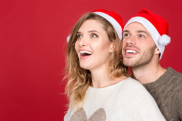 What an offer! Closeup portrait of an excited young couple looking away happily copyspace on the side