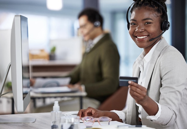 What should we buy today Shot of a young female call center agent holding a credit card at work