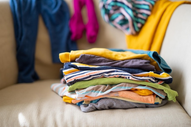 Photo what to wear messy colorful clothing on a sofa