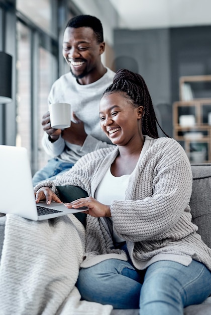 Whats a home without a good wifi connection shot of a young couple using a laptop together on the sofa at home