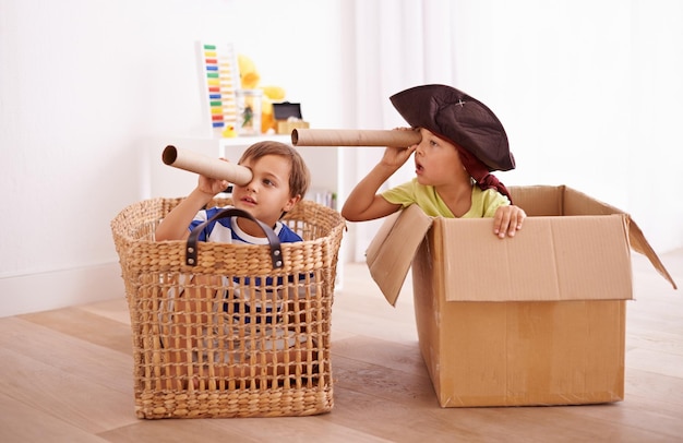 Whats that over there Shot of two little boys pretending to be pirates in their bedroom