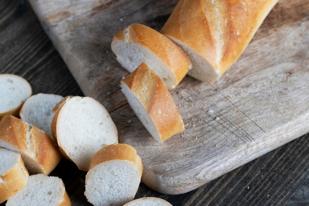 Wheat baguette cut into pieces on a cutting board