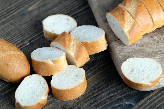 Wheat baguette cut into pieces on a cutting board