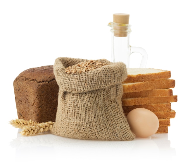 Wheat and bread isolated on white surface