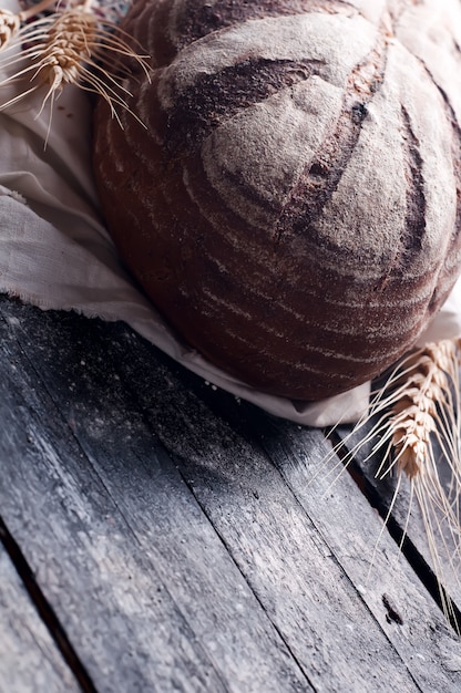 wheat and bread on a wooden table