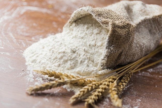 Wheat ears and flour on  background