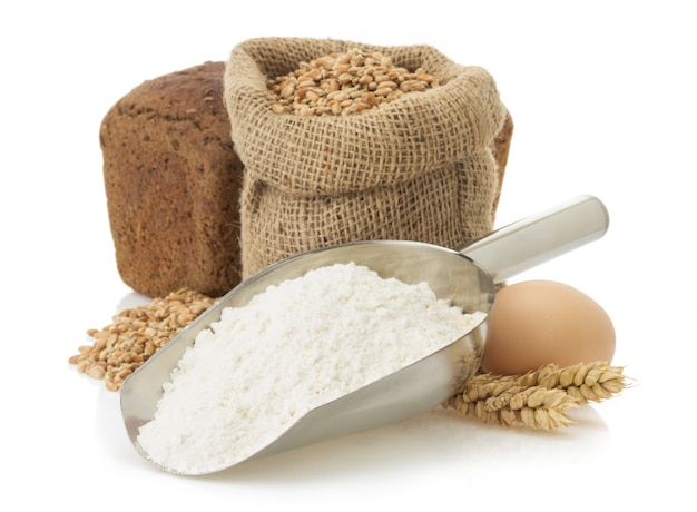 Wheat flour and bread isolated on white surface