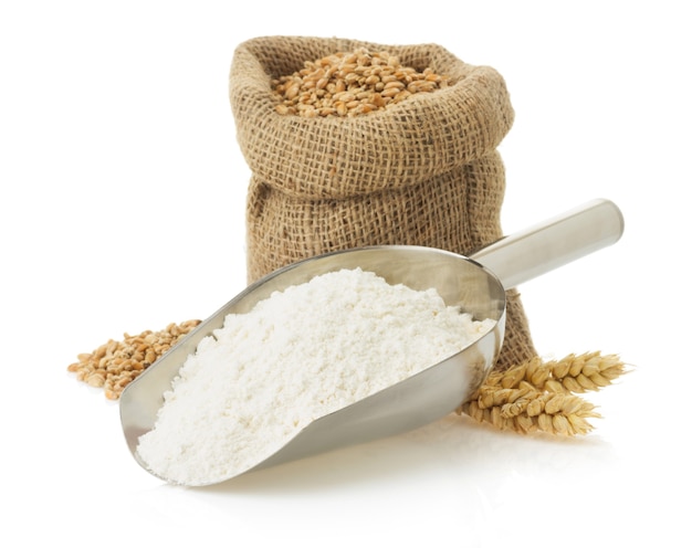 Wheat flour and bread isolated on white surface