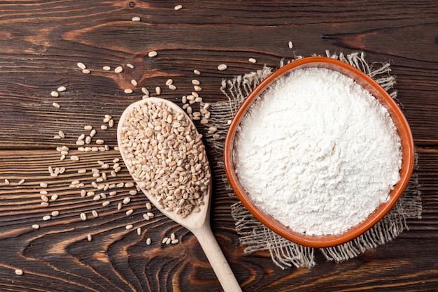 Wheat flour on dark wooden table