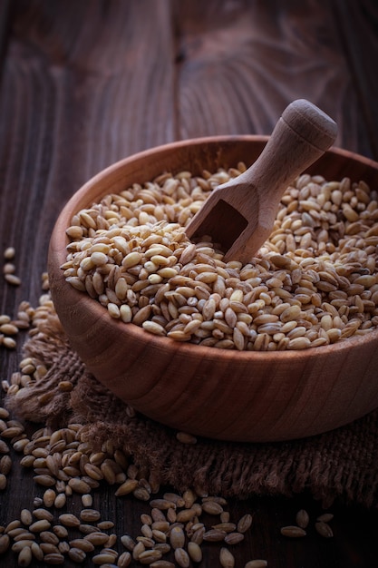 Wheat grain in wooden bowl