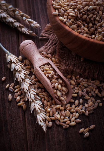 Wheat grain in wooden scoop