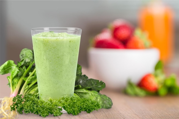 Wheat grass juice with lemon slice in glass