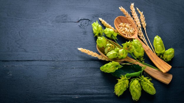 Wheat and hops on a wooden background Top view Free space for text