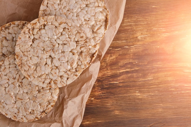 Wheat loaves on food paper on a wooden backgroundHealthy food for weight loss