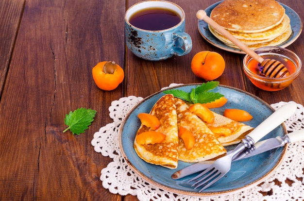 Wheat pancakes with honey and apricots