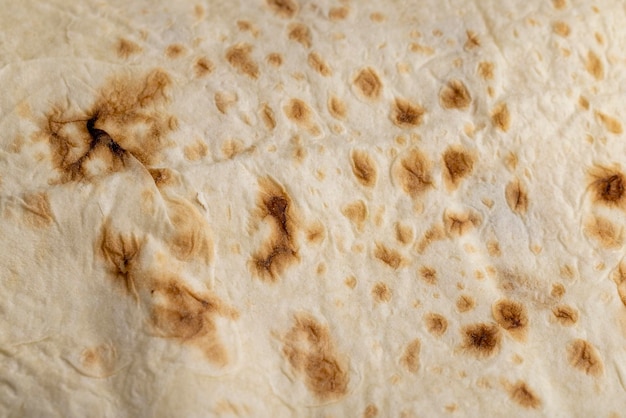 Wheat pita bread with dark spots ovenfried thin pita bread made of wheat flour dough with water